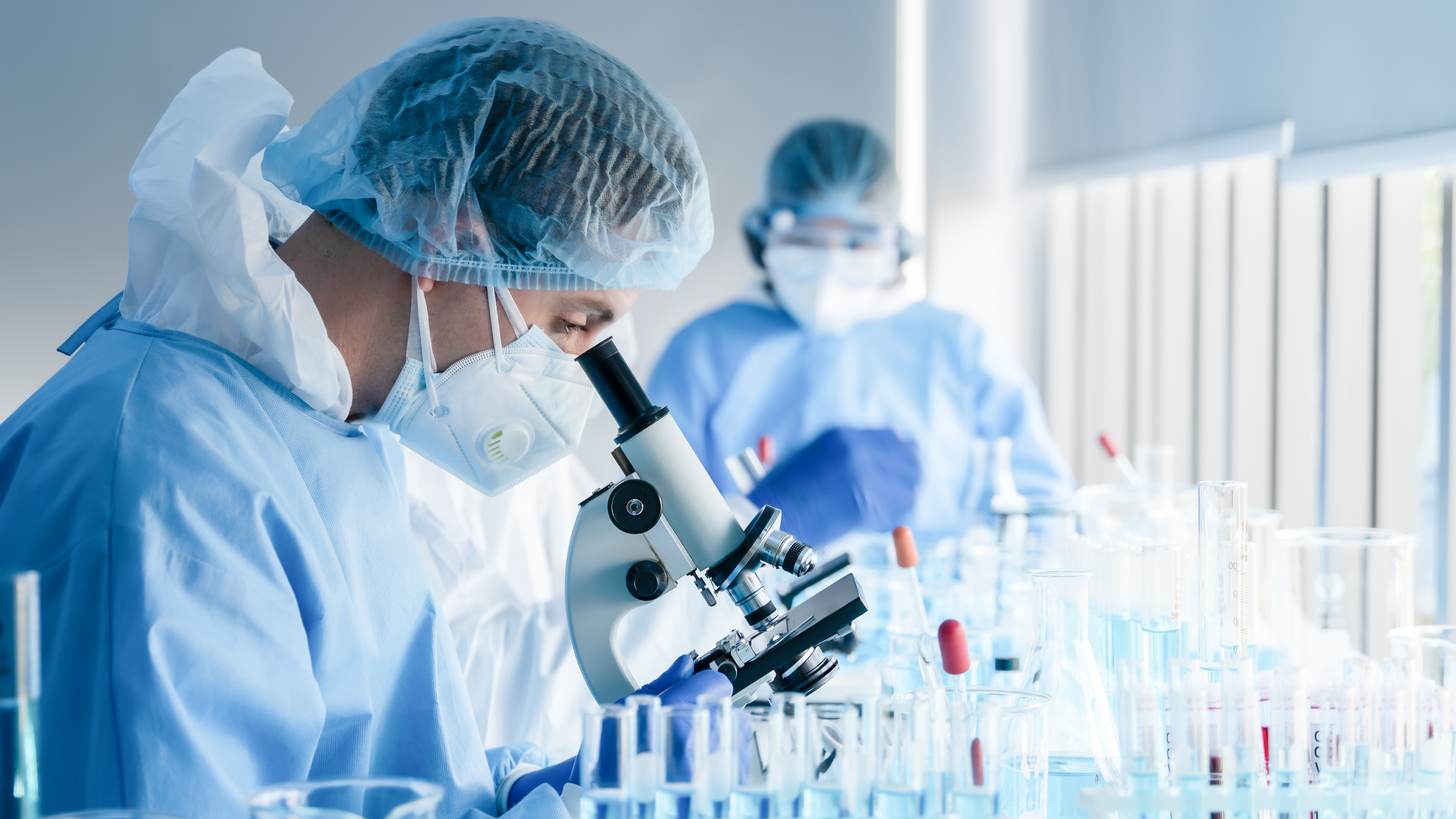 Scientist looking through a microscope